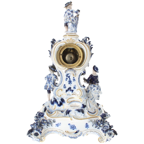 1506 - Good German blue and white porcelain figural mantel clock bearing the cross swords mark, the 2.5