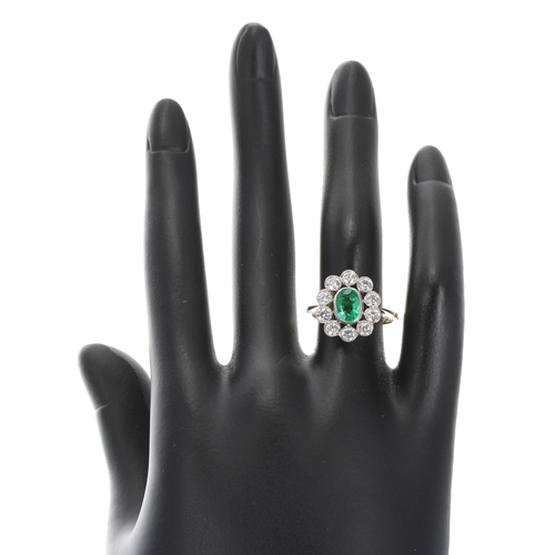 120 - Attractive 18ct and platinum emerald and diamond cluster ring, the emerald 0.90ct in a setting of te... 