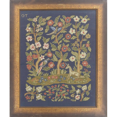 620 - Needlework embroidered picture, depicting birds and a unicorn by trees and flowers, initialled GT to... 