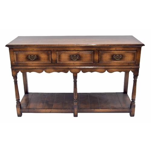 942 - Georgian style oak dresser base, with moulded top over three short drawers over shaped frieze raised... 