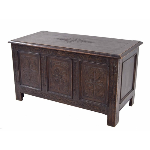 866 - Small antique oak triple panelled coffer, the hinged top with carved floral medallion to the centre ... 