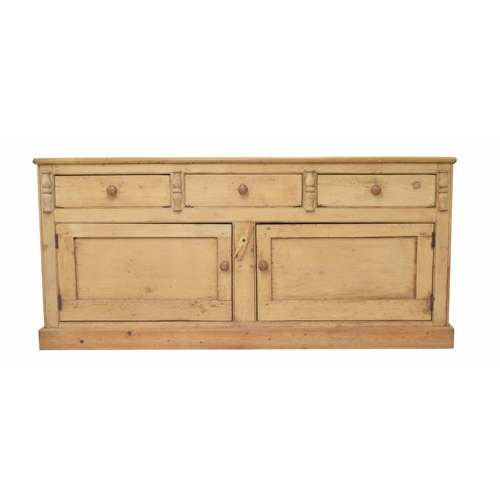 924 - Large Victorian stripped pine farmhouse dresser base, the plain top over three short drawers above t... 