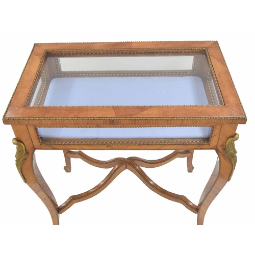 944 - French kingwood bijouterie display table, the glazed hinged cover enclosing a cushioned interior wit... 