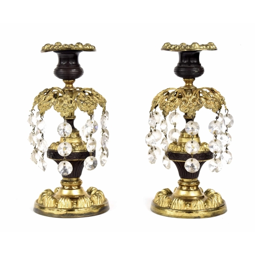 568 - Pair of Regency gilt metal lustre candlesticks, with repousse drip pans over turned gilt and hardwoo... 