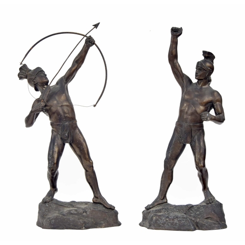 589 - Two spelter figures of Roman gladiators, one an archer, modelled on naturalistic rocky bases, talles... 