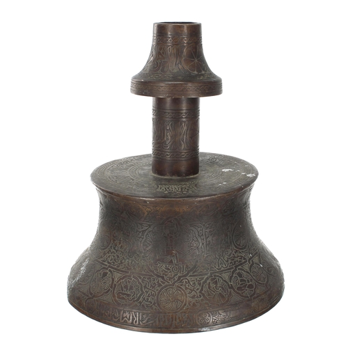 698 - A large copper Islamic Mosque candlestick, decorated with engraved text bands and figural panels amo... 