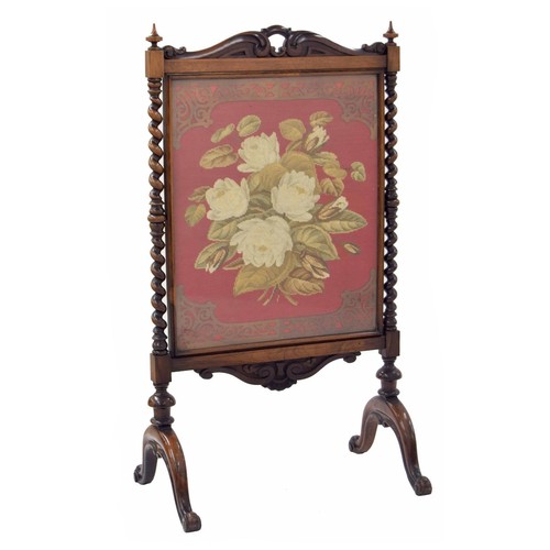 857 - Victorian rosewood glazed fire screen, the embroidered floral image framed behind glass raised on ba... 