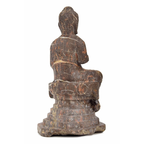 749 - Chinese veined rouge carved marble seated Buddha figure, modelled upon a stepped circular plinth, 15... 