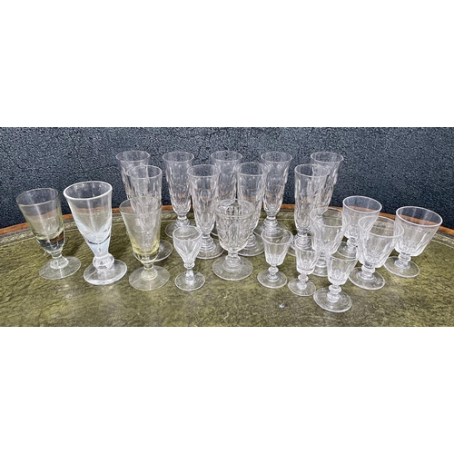 21 - A good selection of antique and later glass to include nine tall ale lens facet cut glasses, wine gl... 