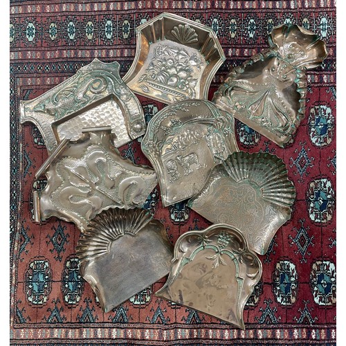 19 - Good selection of decorative repousse copper crumb trays, to include art nouveau and figural example... 