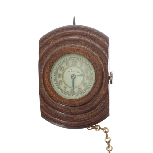 13 - Unusual 'SIRO' lapel watch in a carved wooden case, exhibition back with a Swiss 15 jewel movement, ... 