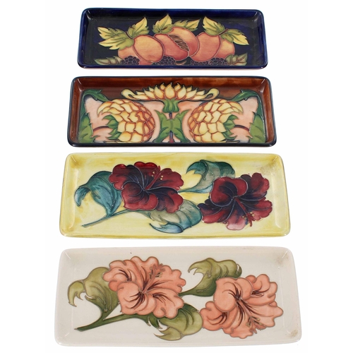 581 - Four Moorcroft Pottery rectangular dishes, each with impressed factory stamps to the bases, one a tr... 