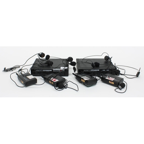 3111 - Selection of Kam wireless microphone systems including four transmitters with headset mics and two r... 