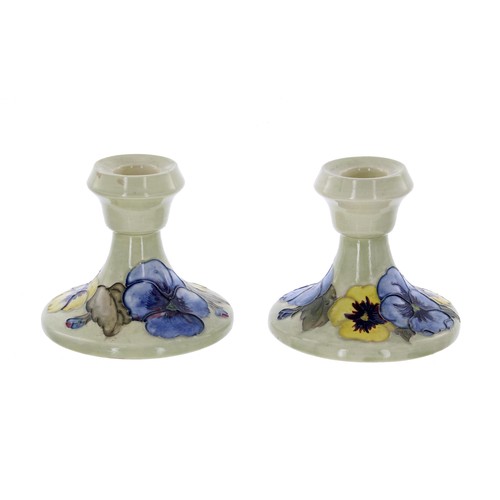 605 - Pair of Moorcroft Pottery 'Pansy' squat candlesticks, bearing Late Queen Mary labels to the base, 3.... 