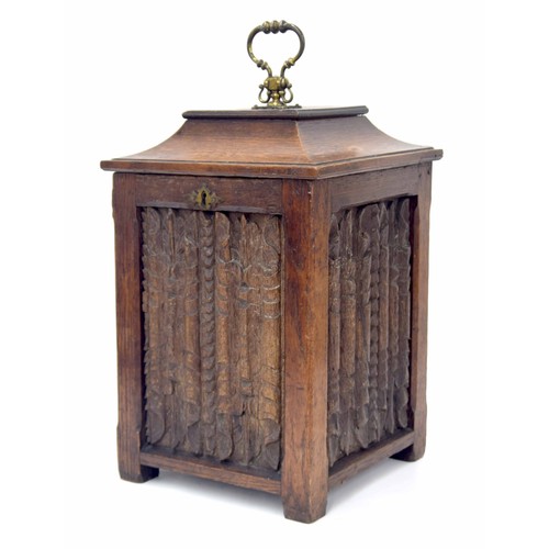 668 - Antique oak fireside coal bucket, the hinged caddy top cover closing a metal liner over four carved ... 