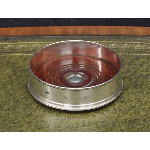 689 - John Bull Ltd. silver wine coaster, with reeded borders on a turned wooden base with green baize to ... 