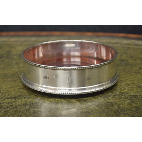 689 - John Bull Ltd. silver wine coaster, with reeded borders on a turned wooden base with green baize to ... 