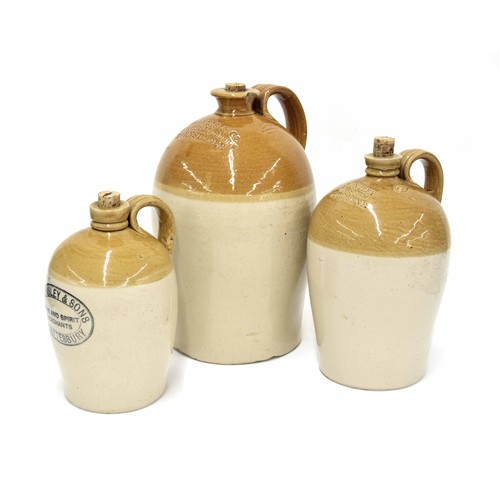 719 - Three stoneware wine/spirit flagons, with impressed branding and stamps, largest 13