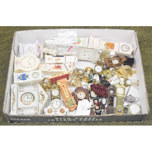 696 - Selection of miniature long case clock ornaments; primarily porcelain souvenir wares; also further m... 