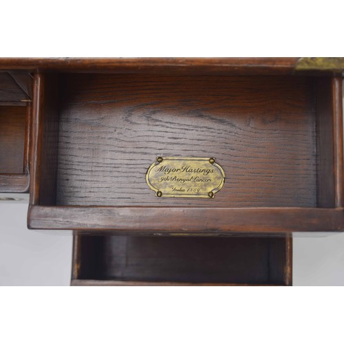 850 - Oak campaign style chest of drawers of small proportions, with brass bound corners and recessed carr... 