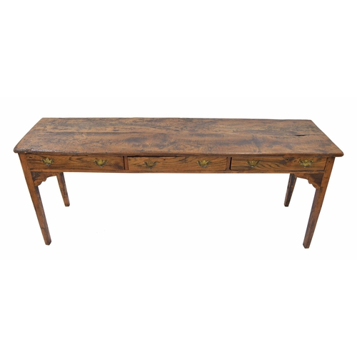 883 - Provincial French elm serving table, the plank top over three short drawers raised on square taperin... 