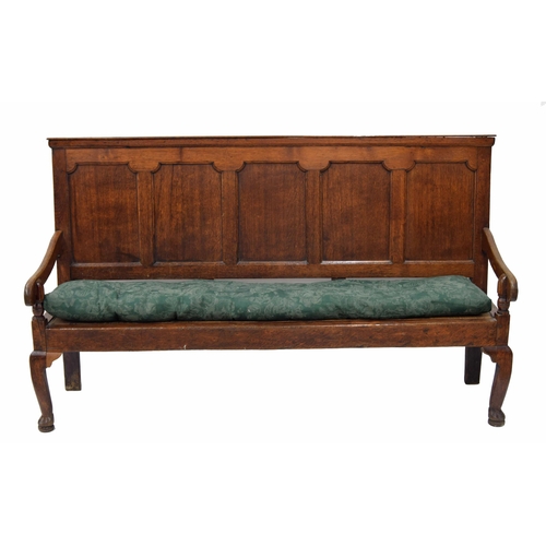 866 - Georgian oak panelled back settle, the five panel back over carved arms on turned supports over a la... 