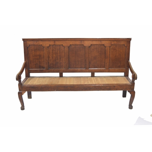 866 - Georgian oak panelled back settle, the five panel back over carved arms on turned supports over a la... 