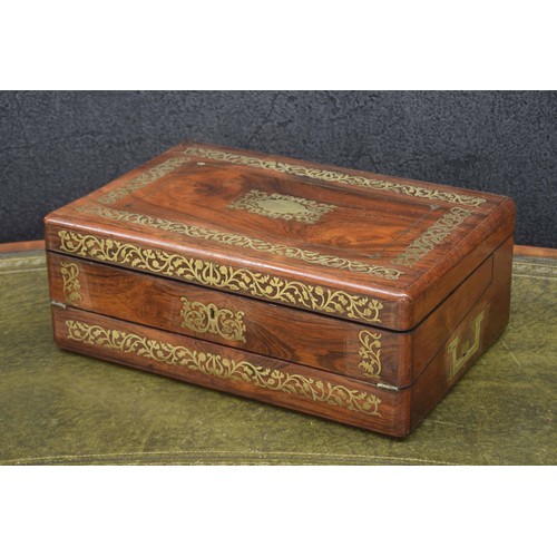 657 - 19th century rosewood and brass inlaid writing slope, the hinged cover with foliate brass inlaid bor... 