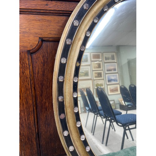 895 - 19th century Irish oval wall mirror, set with faux gem stones to the frame, 23