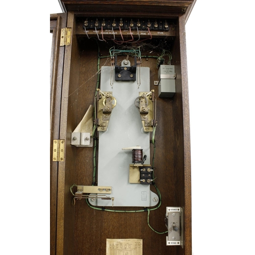 1120 - Gent electric master wall clock, within a dark stained oak glazed case, 55.25