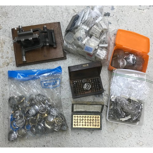 558 - Quantity of watchmakers parts and tools to include wristwatch cases, pocket watch glasses, Boley sta... 