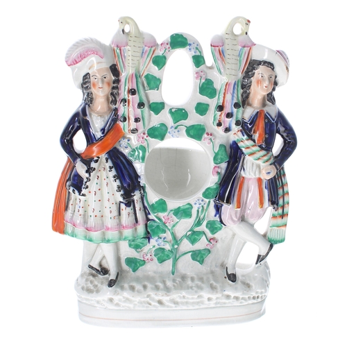 623 - Staffordshire pottery figural pocket watch stand, 10.75'' high approx; together with a further Staff... 