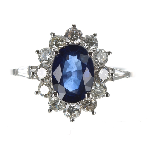 205 - Good quality 18ct white gold ring set with an oval sapphire surrounded by a halo of round brilliant ... 