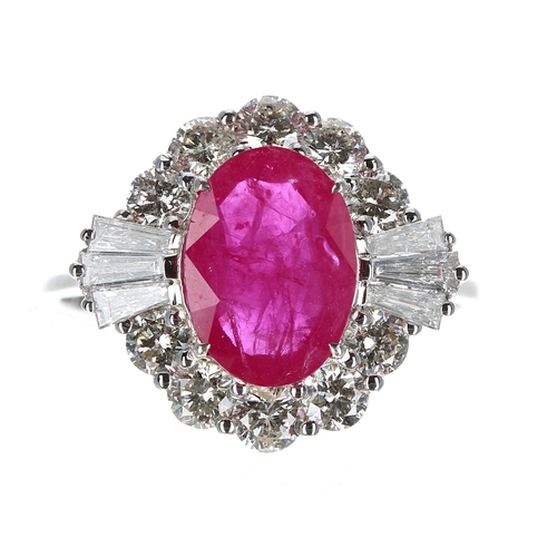 215 - 18ct white gold ring set with oval ruby, surrounded by a halo of round brilliant cut and tapered bag... 