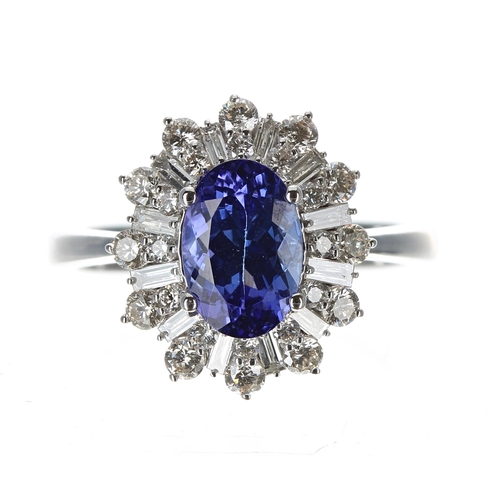 225 - Attractive modern 18ct white gold ring set with an oval tanzanite surrounded by round brilliant cut ... 