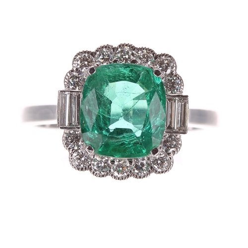 235 - Impressive 18ct white gold emerald and diamond cluster ring in the Art Deco style, the cushion-cut e... 