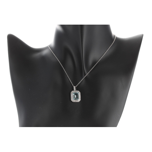 125 - Art Deco style 18ct white gold aquamarine and diamond pendant on a slender 18ct necklace, the aquama... 