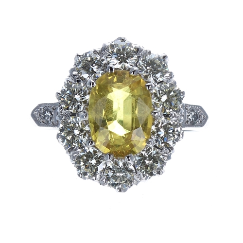 145 - Good platinum yellow sapphire and diamond oval cluster ring, the sapphire 2.50ct approx, in a diamon... 