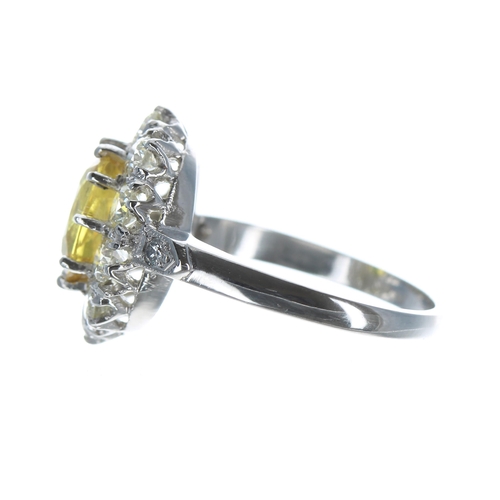 145 - Good platinum yellow sapphire and diamond oval cluster ring, the sapphire 2.50ct approx, in a diamon... 