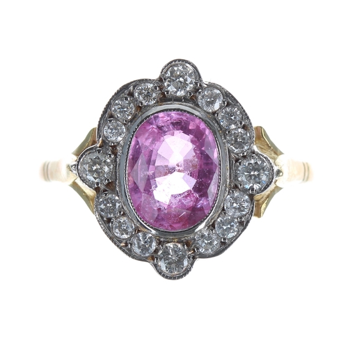 200 - Ornate 18ct yellow gold pink sapphire and diamond oval cluster ring, the sapphire 1.40ct approx, the... 