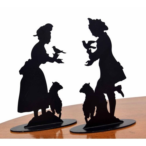 557 - Pair of 'Carolyn Sheffield Designs' metal silhouette figures, each with a dove and sheep by their si... 