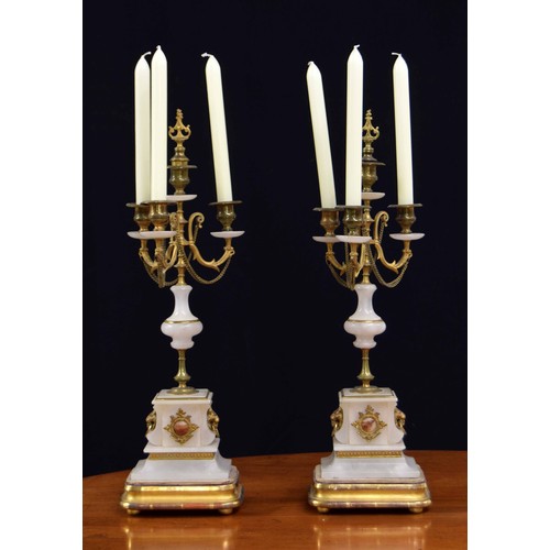 563 - Pair of French alabaster and brass mount candelabra, the bases with applied lion mask and ring handl... 