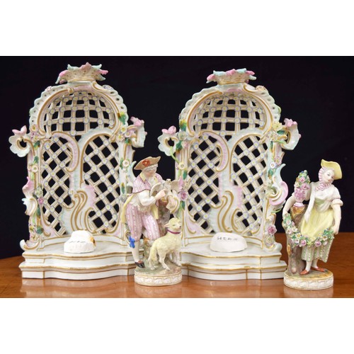 608 - Pair of 19th century German porcelain figures with related arbours, the gentleman modelled with a sh... 