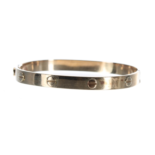 118 - 9ct yellow gold bangle in the style of Cartier, 20.4gm, 66mm wide