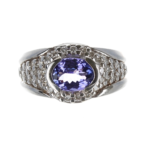 173 - Attractive modern 14ct white gold tanzanite and pavé diamond ring, the tanzanite of good colour esti... 