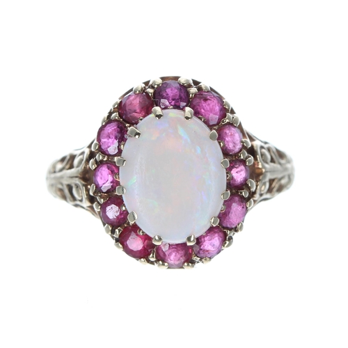 157 - Ornate 9ct cabouchon opal and ruby oval cluster ring, 3.9gm, 15mm x 13mm, ring size M... 