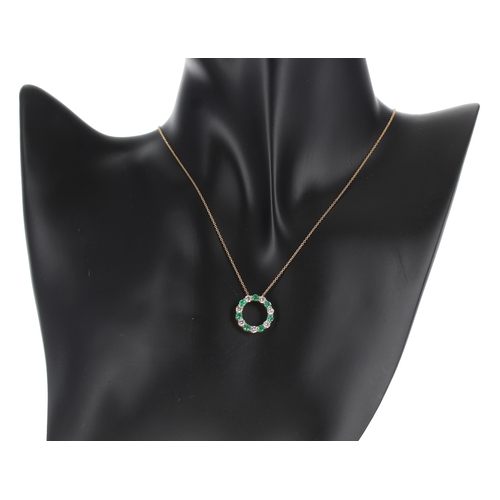 166 - Attractive 18ct yellow gold emerald and diamond circular pendant on chain designed by Luke Stockley ... 