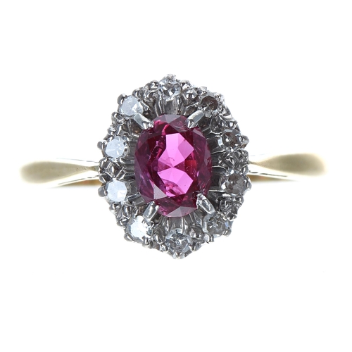 233 - 18ct and platinum ruby and diamond oval cluster ring, the ruby 0.65ct approx, 11mm, 2.7gm, ring size... 