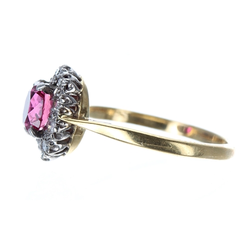 233 - 18ct and platinum ruby and diamond oval cluster ring, the ruby 0.65ct approx, 11mm, 2.7gm, ring size... 