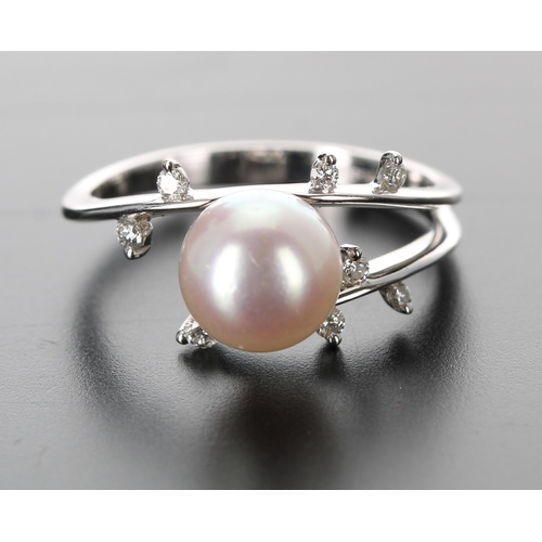 133 - Modern 18ct white gold cultured pearl and diamond dress ring, the pearl 8mm, with eight small round ... 